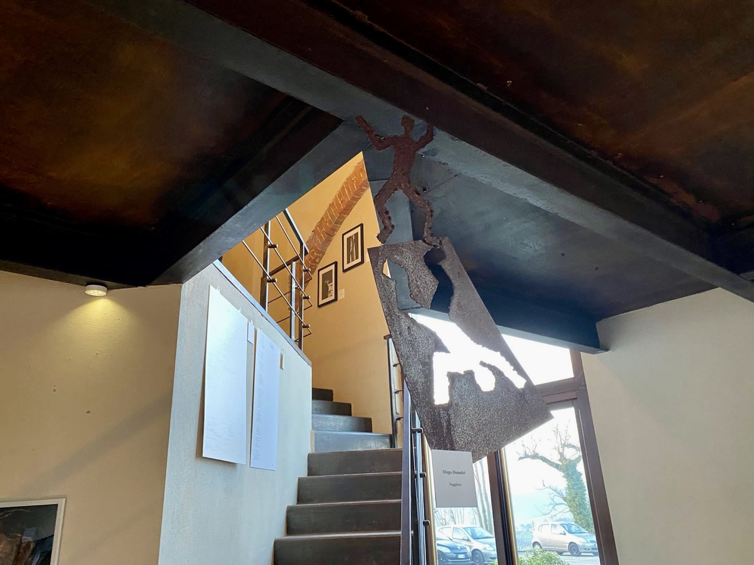 Scultura in ferro sospesa accanto alla scala